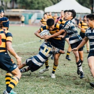 Hommes jouant au rugby, esprit d'équipe, terrain